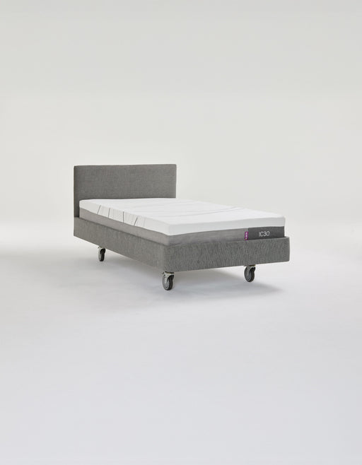 iCare IC100 static partner bed in grey upholstery with a Standard headboard and lockable castors