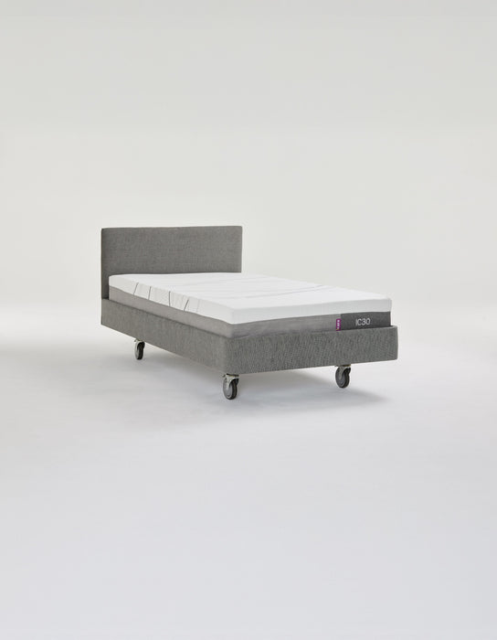 iCare IC100 static partner bed in grey upholstery with a Standard headboard and lockable castors