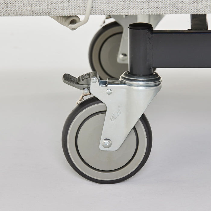 Close-up of a heavy-duty lockable swivel castor on the iCare IC100 partner bed